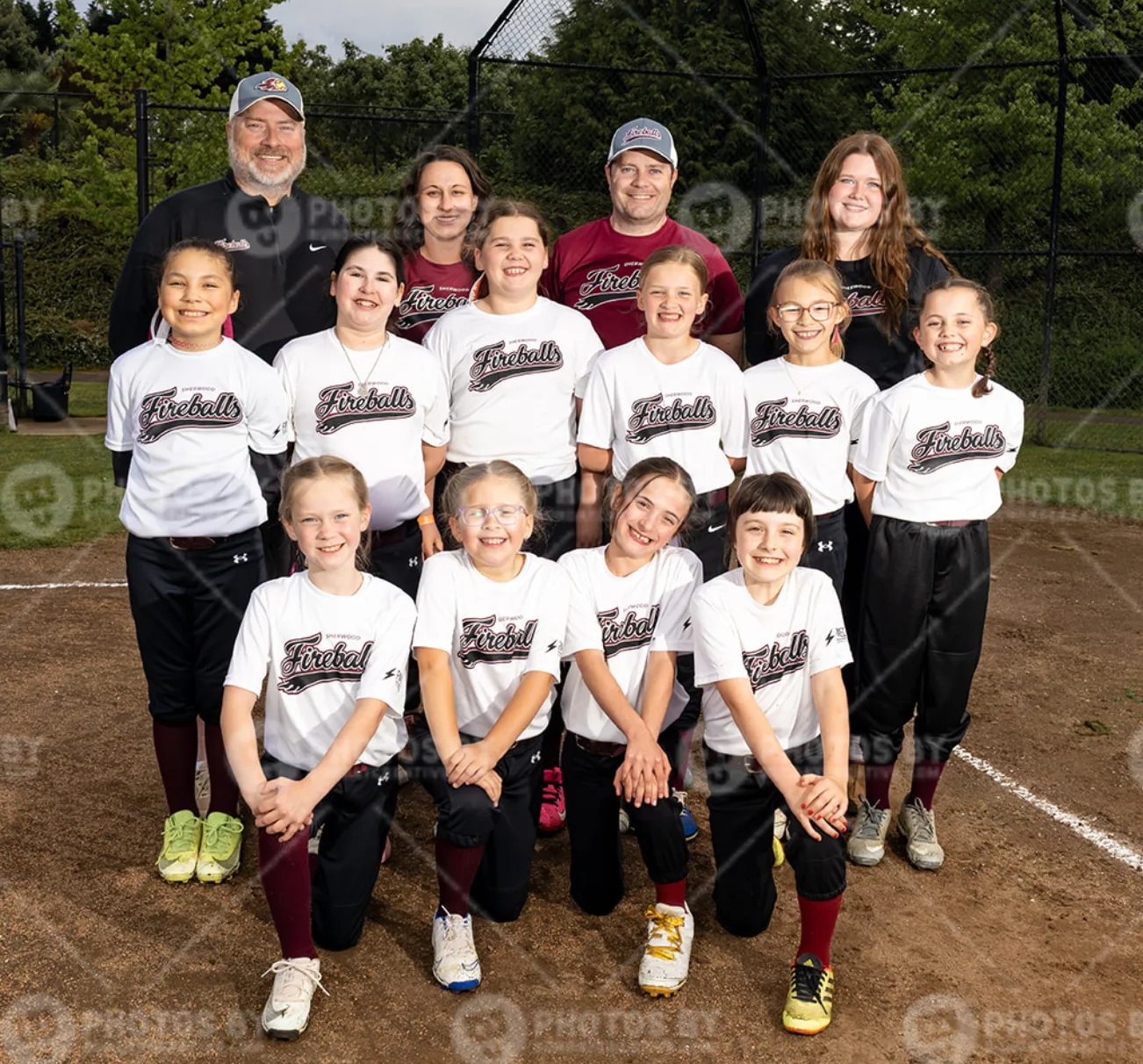 The Fireballs 10U team — the full roster of players in Fireballs jerseys with their three coaches, gathered on the field for a team photo.